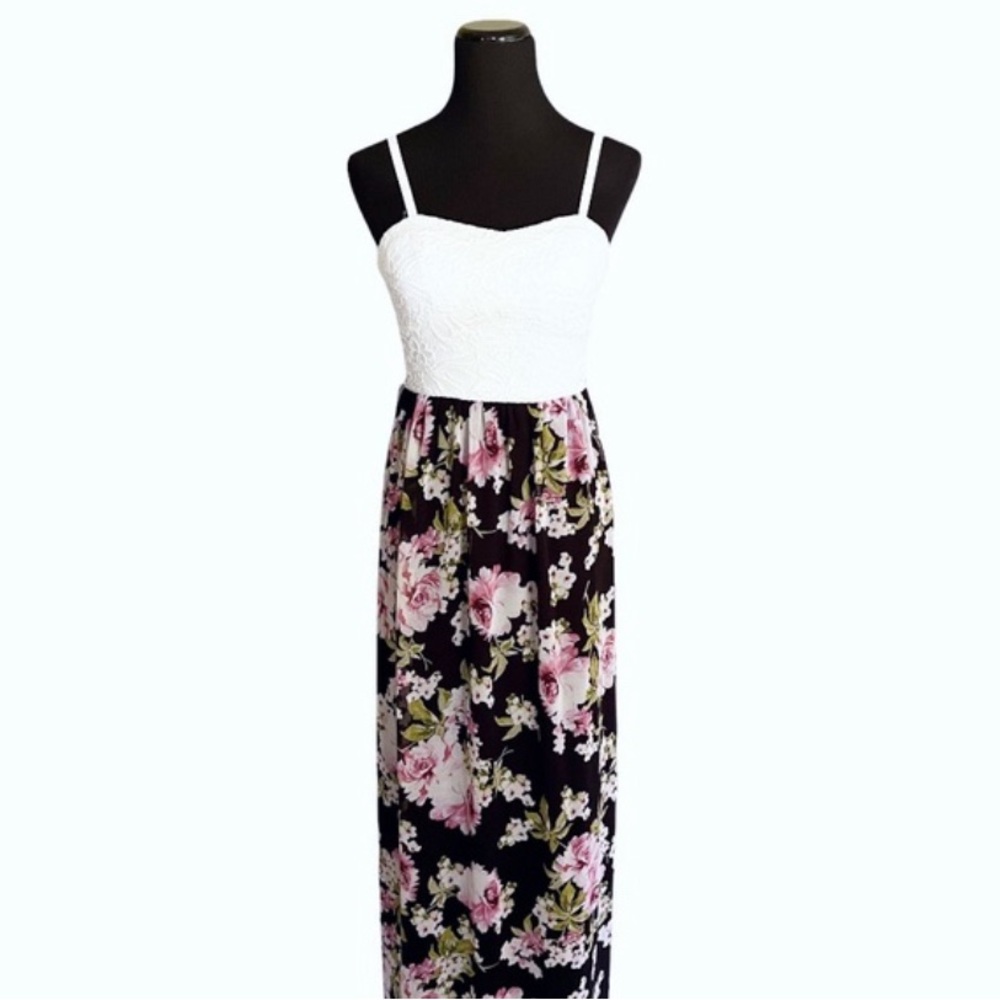 A white lace dress top paired with a flowing floral-print skirt.